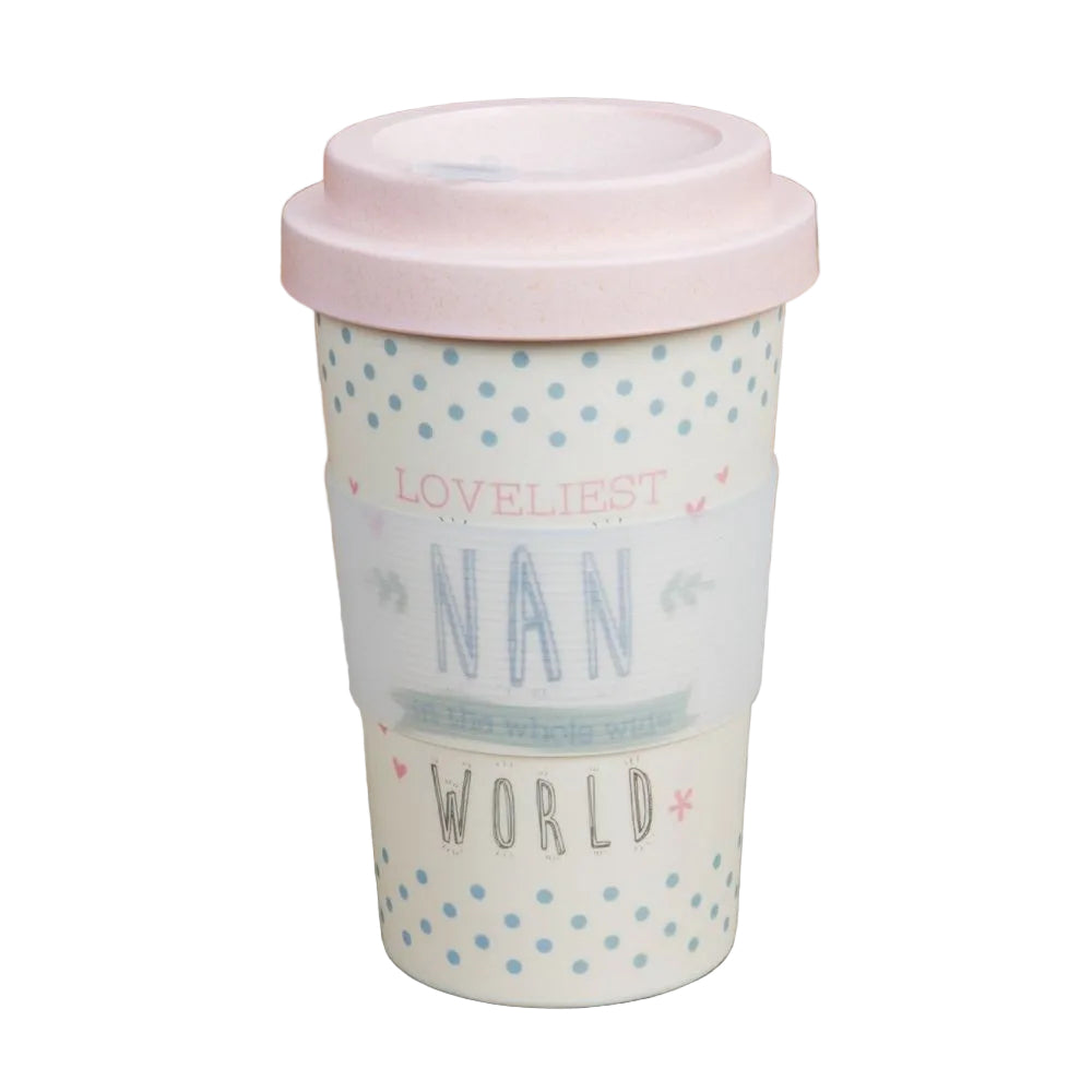 Travel mug with 'Loveliest Nan in the World' text on a wooden surface with coffee beans.